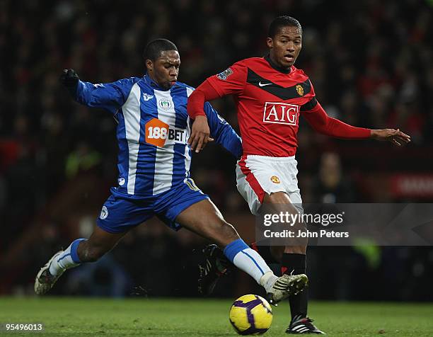 Antonio Valencia of Manchester United clashes with Charles N'Zogbia of Wigan Athletic during the FA Barclays Premier League match between Manchester...