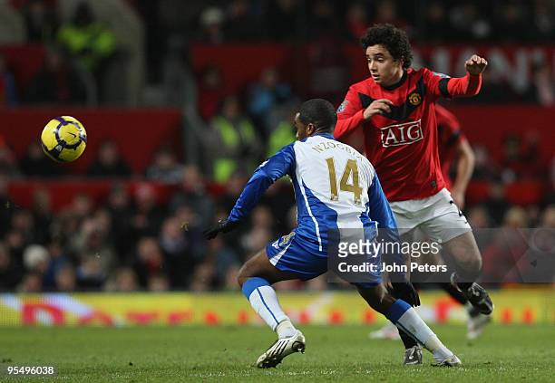 Rafael Da Silva of Manchester United clashes with Charles N'Zogbia of Wigan Athletic during the FA Barclays Premier League match between Manchester...