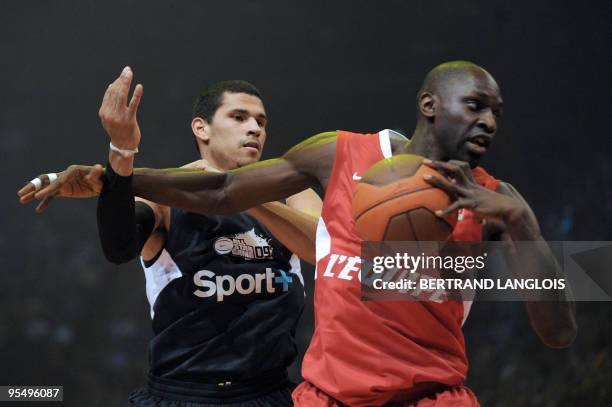 Foreign selection Paris Levallois' Portorican Angel Daniel Vassallo vies with French selection Poitiers Basket 86's Pape Badiane during France's...