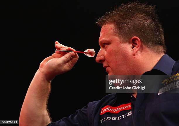 Colin Lloyd of England in action against Ronnie Baxter of England during the 2010 Ladbrokes.com World Darts Championships at Alexandra Palace on...