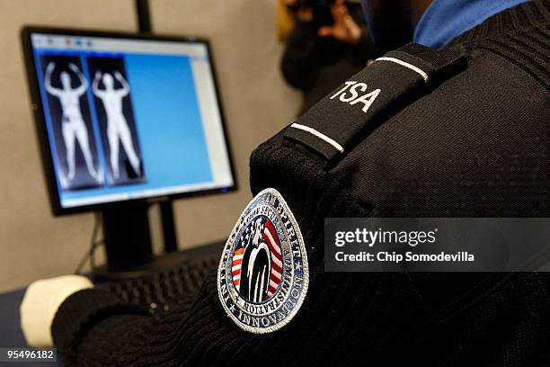 Transportation Security Administration Security Officer Nyamsi Tchapleu looks at images created by a "backscatter" scanner during a demonstration at...