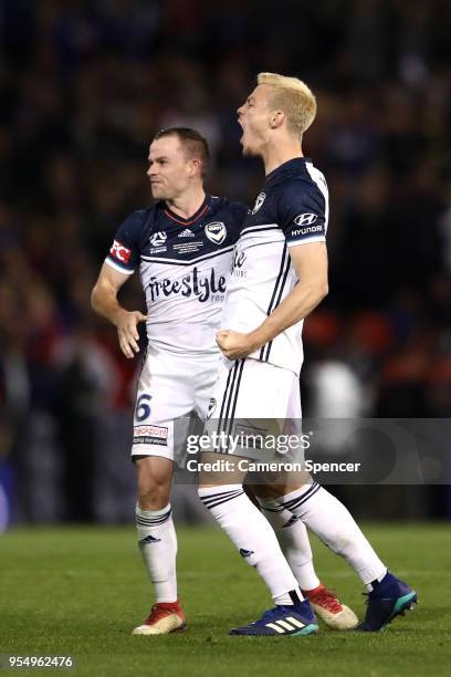 Leigh Broxham of the Victory and James Donachie of the Victory celebrate winning the 2018 A-League Grand Final match between the Newcastle Jets and...