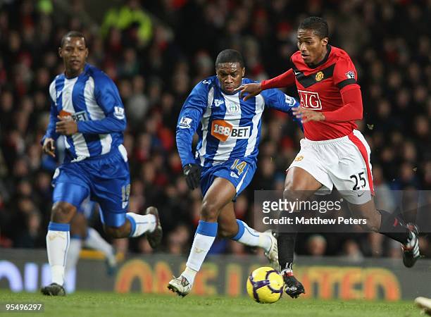Antonio Valencia of Manchester United clashes with Charles N'Zogbia of Wigan Athletic during the Barclays Premier League match between Manchester...