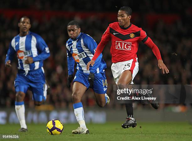 Charles N' Zogbia of Wigan Athletic competes for the ball with Antonio Valencia of Manchester United during the Barclays Premier League match between...
