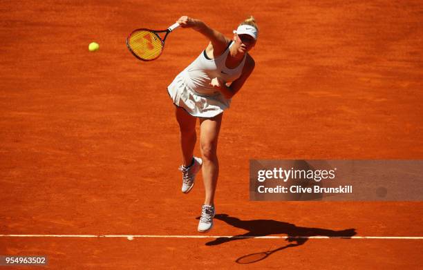 Marta Kostyuk of the Ukraine serves against Lara Arruabarrena of Spain in their first round match during day one of the Mutua Madrid Open tennis...