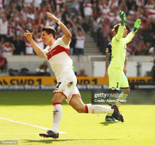 Mario Gomez of VfB Stuttgart celebrates after scoring the first goal while Oliver Baumann of 1899 Hoffenheim is dejected during the Bundesliga match...