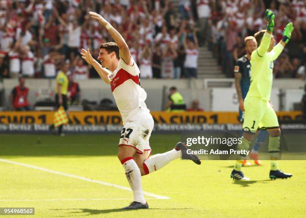 Mario Gomez of VfB Stuttgart celebrates after scoring the first goal while Oliver Baumann of 1899 Hoffenheim is dejected during the Bundesliga match...