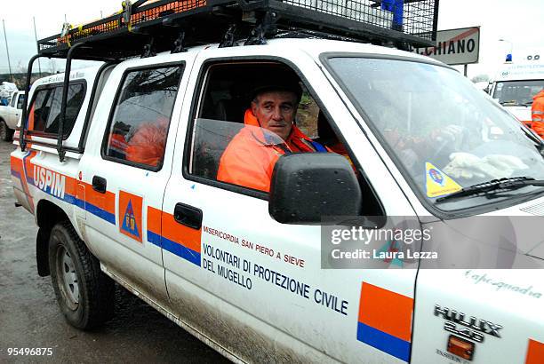 Volunteers of the Civil Defense involved in emergency operations after the flooding of the river Serchio look on on December 29, 2009 in the town of...