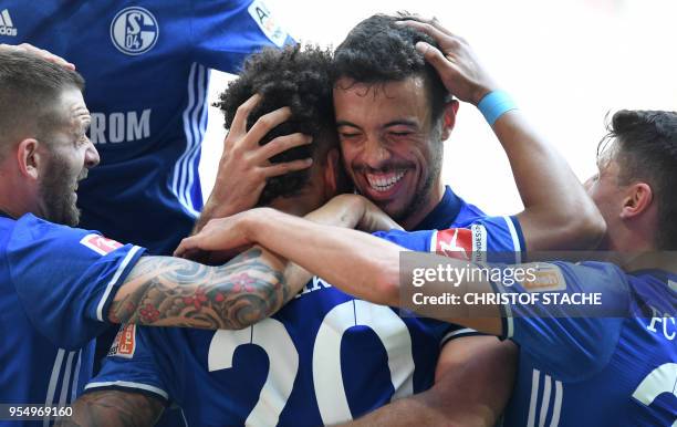 Schalke's German defender Thilo Kehrer is congratulated by Schalke's Argentinian strider Franco di Santo after scoring the first goal during the...