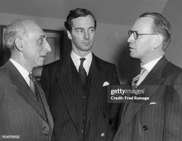 From left to right, Elkan Simons, chairman of the Gifts and Fancy Goods Fair, MP Paul Williams and the Right Honourable A. R. W. Low, Minister of...