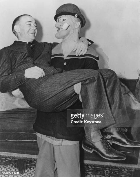 American cartoonist E. C. Segar being carried by actor Harry Foster Welch as an incarnation of Segar's most famous creation, the indomitable sailor...