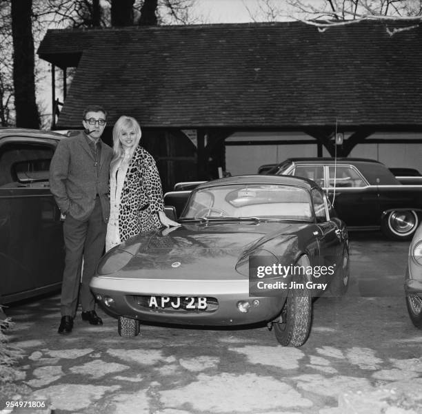 English actor Peter Sellers presents a Lotus Elan to his fiancée, actress Britt Ekland, 12th February 1964.