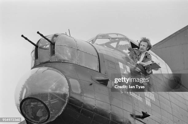 British artist David Shepherd takes sketches from the cockpit of the 'City of Lincoln', Britain's only remaining Lancaster bomber, at the RAF...