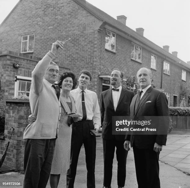 Desmond Plummer , leader of the GLC hands over a ceremonial key to Mr Regan, buyer of the first GLC council house, at the Harold Hill Estate in...