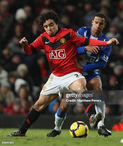 Rafael Da Silva of Manchester United clashes with Scott Sinclair of Wigan Athletic during the Barclays Premier League match between Manchester United...