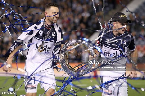 Victory captain Carl Valeri and Leigh Broxham of the Victory celebrate with the trophy after winning the 2018 A-League Grand Final match between the...