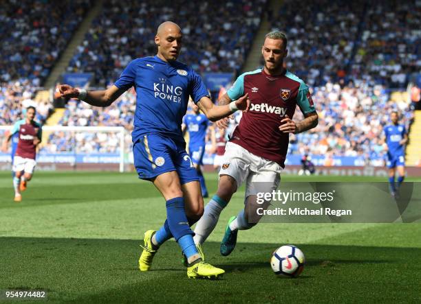 Yohan Benalouane of Leicester City and Marko Arnautovic of West Ham United battle for the ball during the Premier League match between Leicester City...