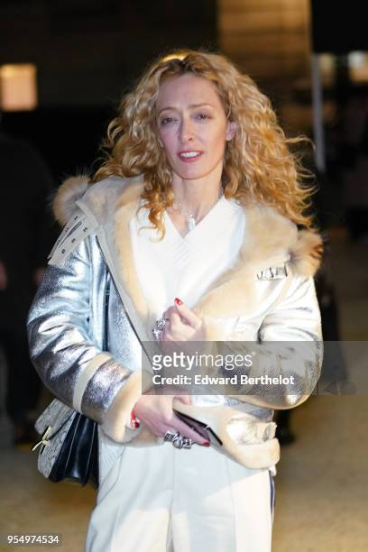 Elina Halimi wears a silver jacket, a white top, white pants, outside Valentino, during Paris Fashion Week - Menswear Fall Winter 2018-2019, on...