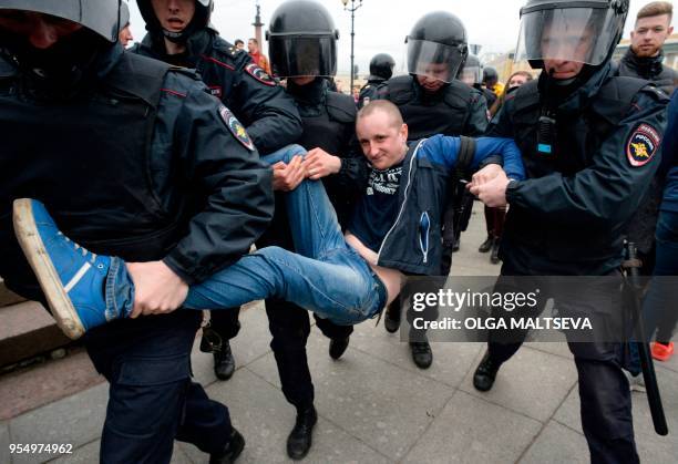 Russian police officers detain a protester during an unauthorized anti-Putin rally called by opposition leader Alexei Navalny on May 5, 2018 in Saint...