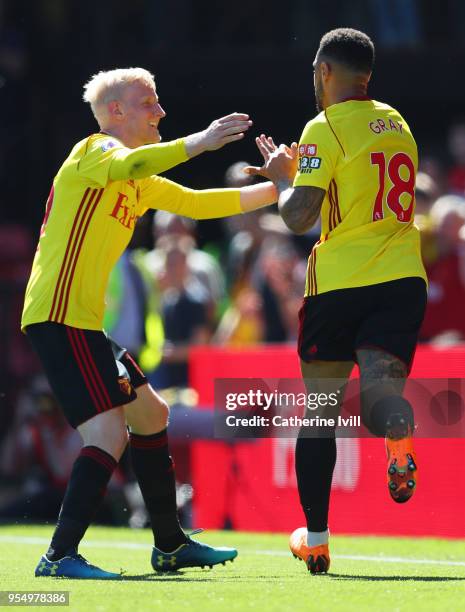 Andre Gray of Watford celebrates scoring his side's second goal with team mate Will Hughes during the Premier League match between Watford and...