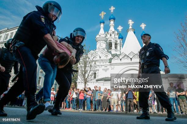 Russian police officers detain a protester during an unauthorized anti-Putin rally called by opposition leader Alexei Navalny on May 5, 2018 in...