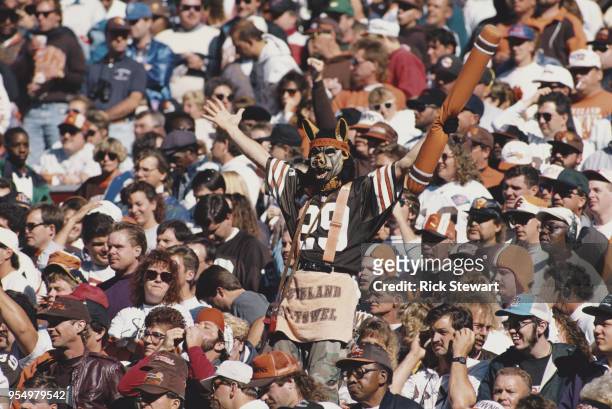 Fan for the Cleveland Browns complete with dog like mask supports his team from the dog pound section of the bleechers during the American Football...