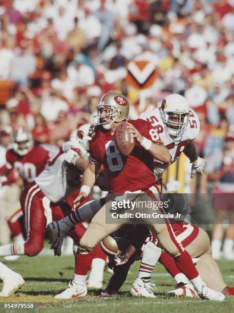 Steve Young, Quarterback for the San Francisco 49ers abot to be sacked by Eric Hill during the National Football Conference West Divisional game...