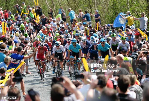 Riders in the peloton climb up the iconic Sutton Bank during the third stage of the Tour de Yorkshire cycling race on May 5, 2018 in Thirsk, United...