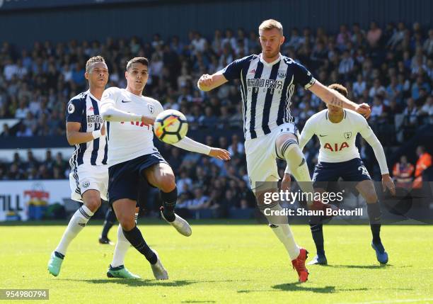 Erik Lamela of Tottenham Hotspur battles for possession with Chris Brunt of West Bromwich Albion during the Premier League match between West...