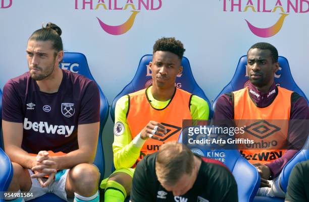 Andy Carroll of West Ham United sits on the bench with Nathan Trott and Pedro Obiang prior to the Premier League match between Leicester City and...