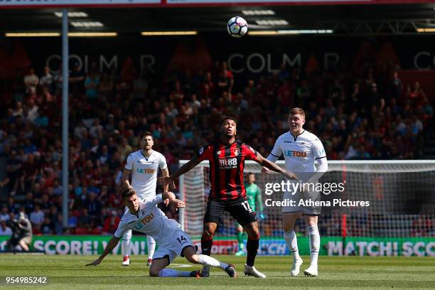 Joshua King of Bournemouth wins the header as he is challenged by Tom Carroll and Alfie Mawson of Swansea City during the Premier League match...