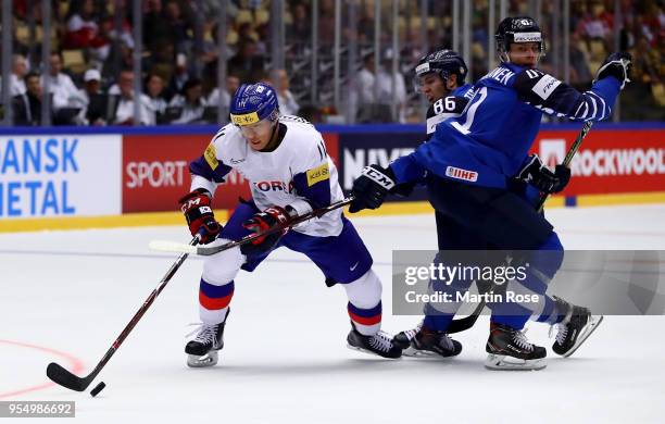 Teuvo Teravainen of Finland and Kisung Kim of Korea battle for the puck during the 2018 IIHF Ice Hockey World Championship group stage game between...