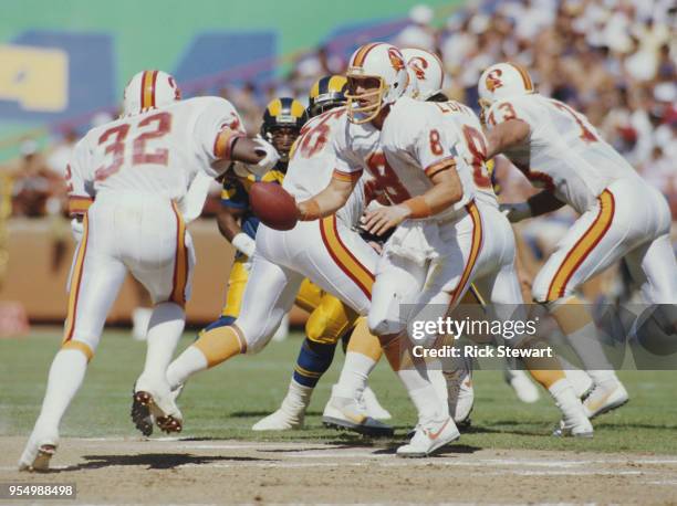Steve Young, Quarterback for the Tampa Bay Buccaneers feeds the ball to Running Back James Wilder during the American Football Conference West game...