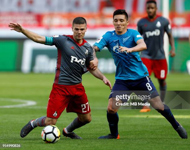 Igor Denisov of FC Lokomotiv Moscow and Matias Kranevitter of FC Zenit Saint Petersburg vie for the ball during the Russian Football League match...