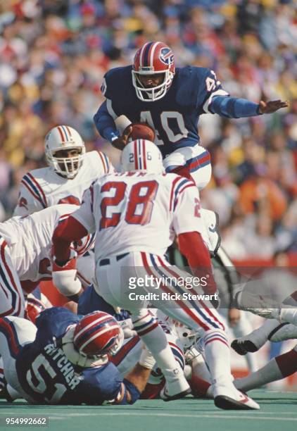 Robb Riddick, Running Back for the Buffalo Bills jumps over the Patriots defence during the American Football Conference East game against the New...