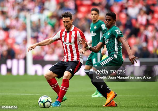 Junior Firpo of Real Betis competes for the ball with Aritz Aduriz of Athletic Club during the La Liga match between Athletic Club Bilbao and Real...