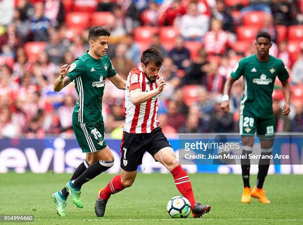 Marc Bartra of Real Betis competes for the ball with Benat Etxebarria of Athletic Club during the La Liga match between Athletic Club Bilbao and Real...