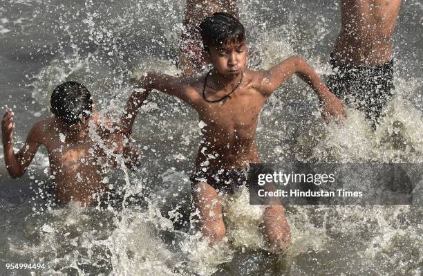 Children take a dip at the Yamuna River, Kalindi Kunj during a hot weather, on May 5, 2018 in Noida, India. Dry and uneasy weather will continue over...