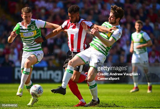 Lincoln City's Matt Green gets between Yeovil Town's Shaun Donnellan, left and Corey Whelan, right, during the Sky Bet League Two match between...