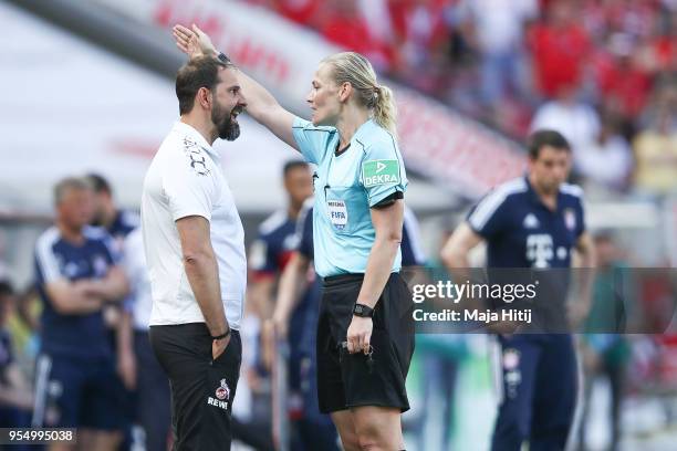 Refeere Bibiana Steinhaus argues with Stefan Ruthenbeck Head Coach of 1. FC Koeln as he is send out during the Bundesliga match between 1. FC Koeln...