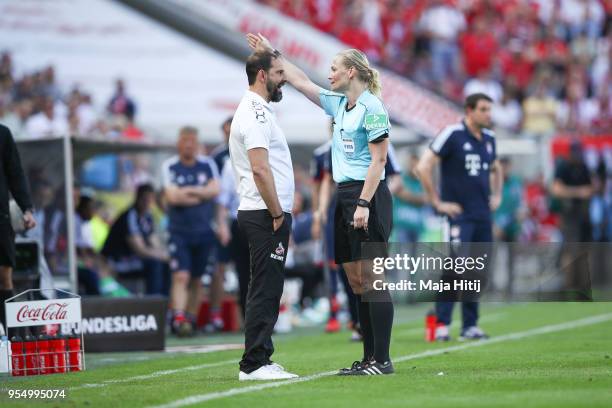 Refeere Bibiana Steinhaus argues with Stefan Ruthenbeck Head Coach of 1. FC Koeln as he is send out during the Bundesliga match between 1. FC Koeln...