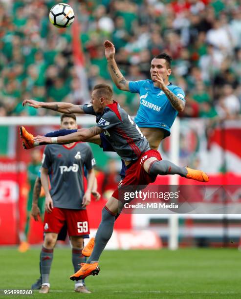Dmitri Tarasov of FC Lokomotiv Moscow and Anton Zabolotny of FC Zenit Saint Petersburg vie for the ball during the Russian Football League match...