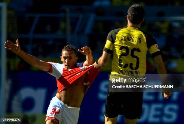 Dortmund's Greek defender Sokratis Papastathopoulos pulls the shirt of Mainz's Argentinean forward Pablo De Blasis during the German first division...