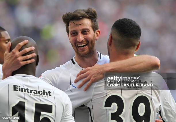 Frankfurt's Argentinian defender David Abraham celebrates with teammates after Frankfurt's Spanish midfielder Omar Mascarell scored the 2-0 during...