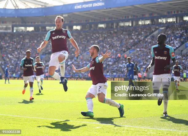 Mark Noble of West Ham United celebrates scoring his side's second goal with team mates Marko Arnautovic and Cheikhou Kouyate during the Premier...