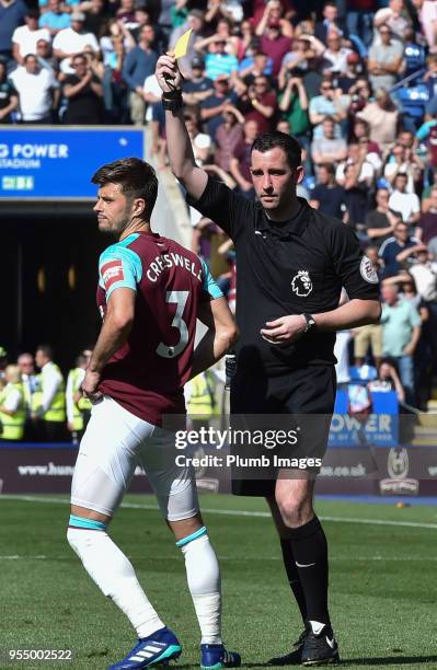 Aaron Cresswell of West Ham United is shown a yellow card by referee Christopher Kavanagh for a handball during the Premier League match between...