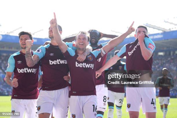 Mark Noble of West Ham United celebrates scoring his side's second goal with team mates during the Premier League match between Leicester City and...