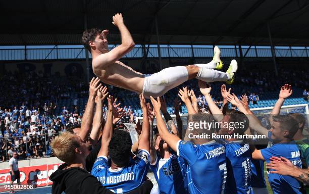 Players of 1. FC Magdeburg tosses their team captain Marius Sowislo into the air after the 3. Liga match between 1. FC Magdeburg and Chemnitzer FC at...