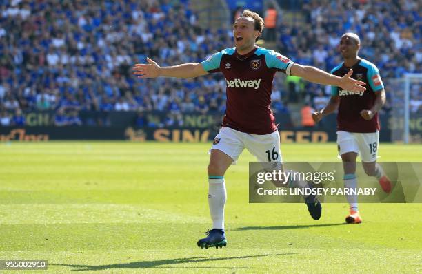 West Ham United's English midfielder Mark Noble celebrates scoring his team's second goal during the English Premier League football match between...