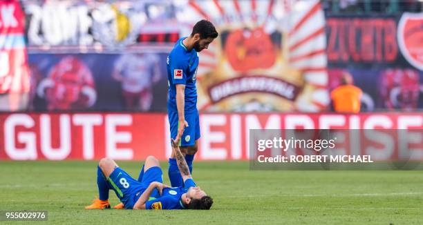 Wolfsburg´s midfielder Renato Steffen and Turkish midfielder Yunus Malli react after loosing the German first division Bundesliga football match RB...